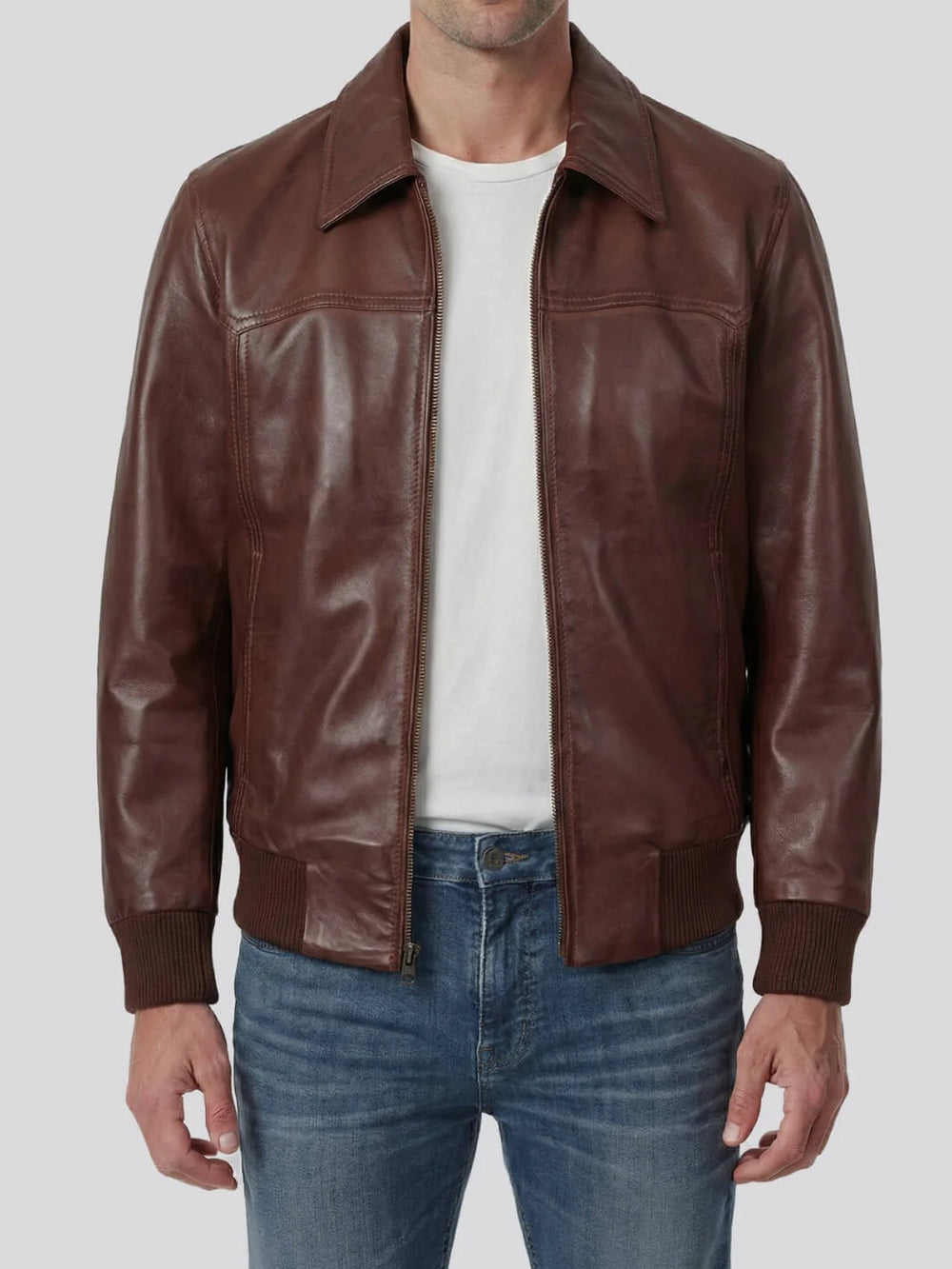 Brown leather jacket worn by a person on a white background